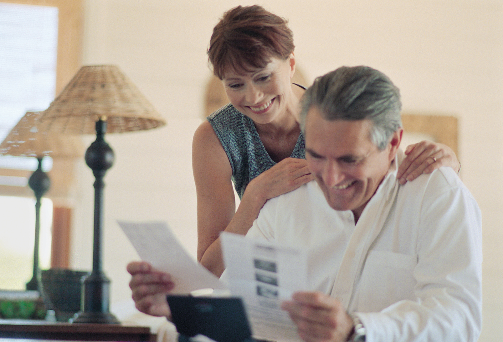 Couple at home looking at paperwork