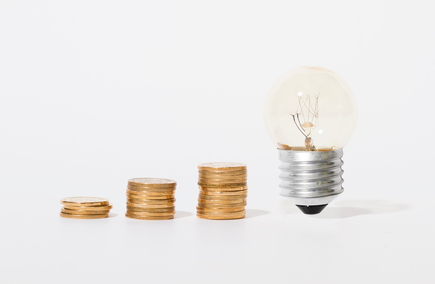 Coins and bulbs, wealth accumulation and inspiration hope, goals and aspirations